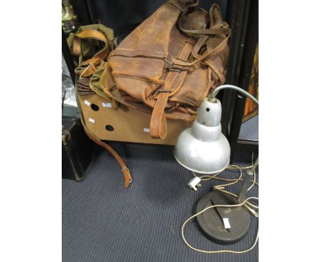A collection of leather goods including sample case, skates, and belts, and a tin shade lamp  