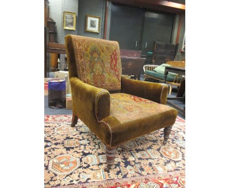 A Howard style armchair with carpet upholstery and turned front legs and castors, stamped rear leg A4959  