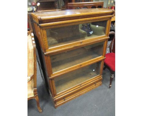 A pair of medium oak Globe Wernicke 3 section stacking bookcases with a drawer to the plinth base  