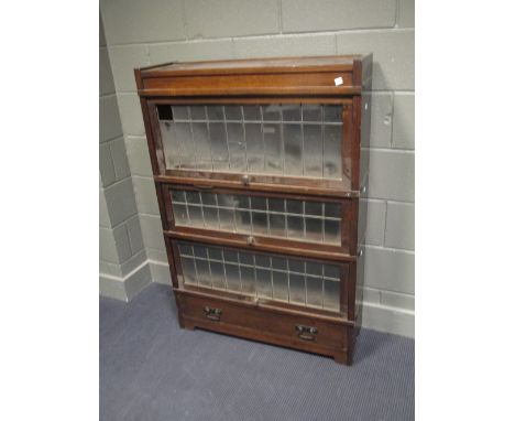 An oak Globe Wernicke style bookcase enclosed by leaded glass lift up fronts, H127cm W88cm D29cm  