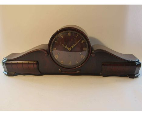 A mid 20th Century mahogany striking and chiming mantel clock of drum and scrolled form with brass Roman numerals and pierced
