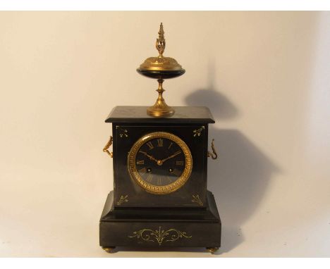 A late 19th Century slate mantel clock with gilt spelter surmounting urn and and winged side mounts, black Roman dial with gi