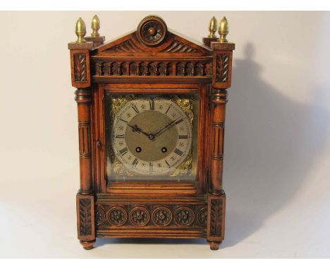 A late Victorian walnut cased mantel clock of architectural design, brass dial with silvered Roman chapter ring, 8-day moveme