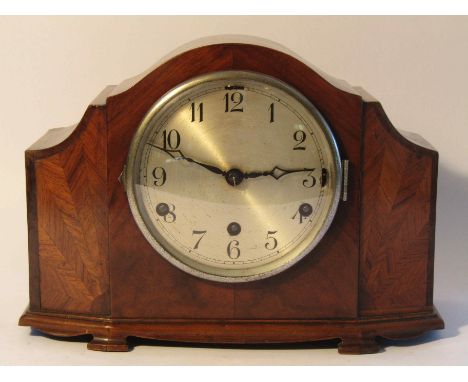 An early to mid 20th Century walnut veneered mantel clock, Arabic silvered dial with Anvil striking and chiming movement with