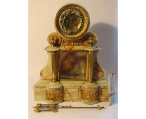 A late 19th Century large onyx French mantel clock of architectural form with gilt column supports and panels depicting cheru