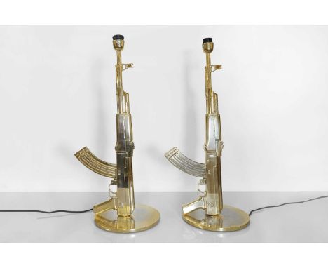 A pair of Italian 'Gun' table lamps, designed in 2005 by Philippe Starck for Flos, each of die-cast aluminium in the form of 