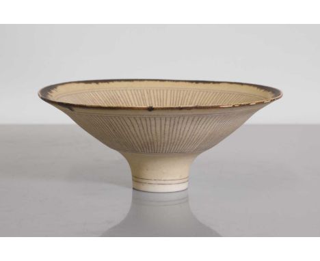 ▴ Dame Lucie Rie (Austrian, 1902-1995), a stoneware footed bowl, finished in a manganese glaze to the rim, the inside with a 