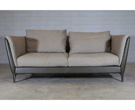 A 'Bretagne' two seater sofa, modern, designed and manufactured by Poltrona Frau, the frame upholstered in green leather, wit