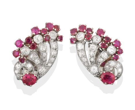 A Pair of Diamond and Ruby Ear Clips circa 1925, of stylised fan motifs with floral terminals, set throughout with old cut di