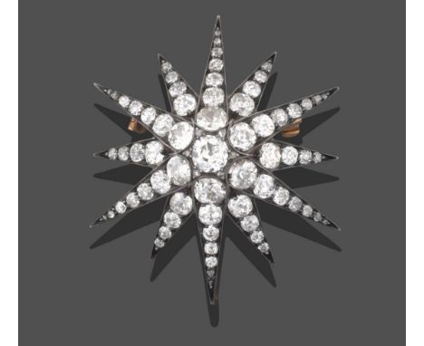 A Victorian Diamond Star Brooch/Pendant, the central raised old cut diamond with rose cut diamond accents, within a border of