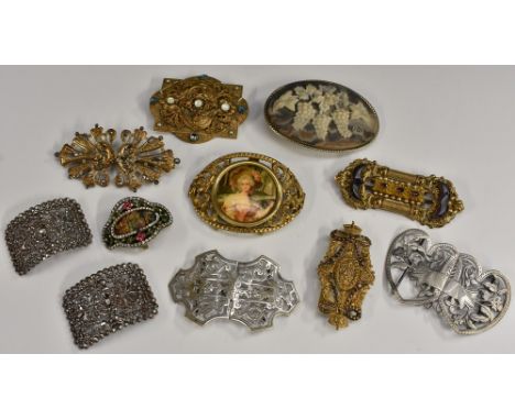 A quantity of buckles and brooches to include cut steel shoe buckles; a amethyst glass set brooch converted from a buckle; ot