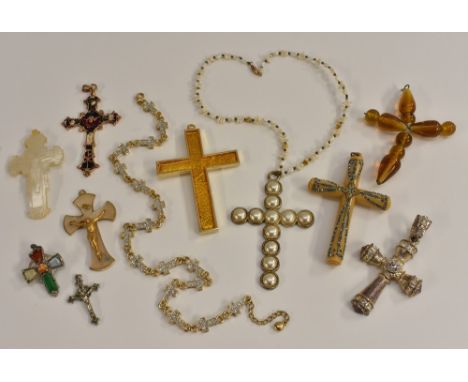 A carved mother of pearl cross pendant; others Celtic style, amber coloured glass, pale creamy brown banded bakolite, gilt me