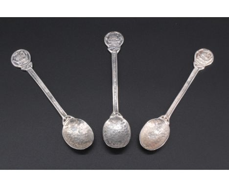 Three early 20th Century Scottish provincial silver souvenir spoons, having a hammered finish and terminals featuring a longs