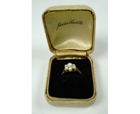 A 9 ct gold and pearl cluster set ring, having a central pearl set above six smaller stones on a plain shank, London, 1970, N