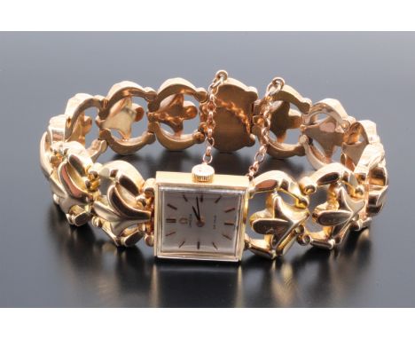A lady's Omega 18 ct yellow metal dress or cocktail watch, having a calibre 484 manual wind movement and silvered square face