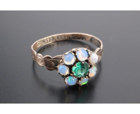 A Victorian opal and green paste ring, the flowerhead arrangement of stones claw set on a 9 ct gold shank between cusped and 