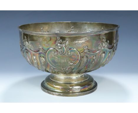 A late Victorian silver punch bowl, the bowl repouse worked and engraved with pronounced spiral gadrooning capped by cusped f