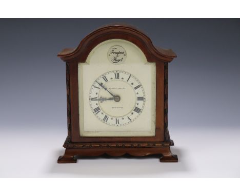 A Edwardian influenced Robert Sawers carved walnut clock, having a key wound movement and platform escapement, circa 1930s, f