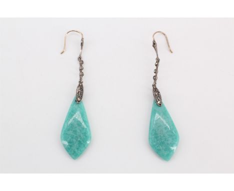 A pair of Art Deco influenced jade / nephrite ear pendants, the polished spearhead-shaped drops dependant on articulated marc