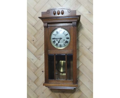 A 1920s - 1930s oak cased wall clock, 80 x 30 x 16 cm