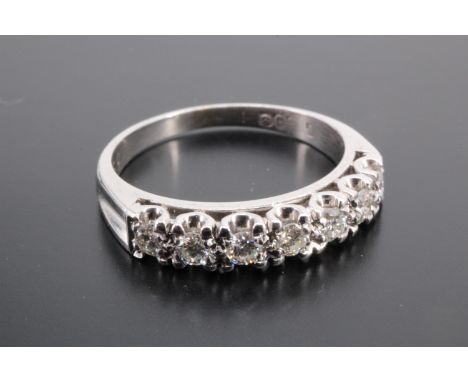 A diamond and high carat precious white metal half hoop eternity ring, set with seven diamonds of approximately 0.2 ct aggreg