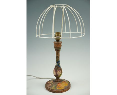 A carved and painted wooden lamp, 29 cm 