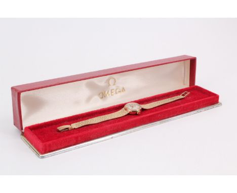 An early 1970s Omega lady's 9 ct gold dress watch, having a calibre 485 manual wind movement, circular face an granular-textu