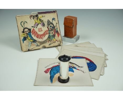A mid 19th Century French optical toy entitled "Les Anamorphes", being a set of 24 hand-tinted printed card anamorphic cards 