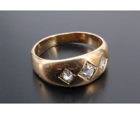 An antique gypsy set diamond ring, the broad tapering D-section shank set with three brilliants millegrain-set in lozenge-sha