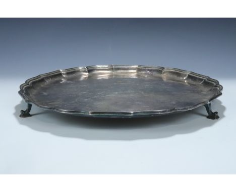 A 1930s silver salver, having a Chippendale style rim and scroll feet, Roberts &amp; Belk, 30 cm, approx 840 g