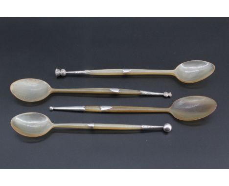 A collection of four Edwardian Scottish silver mounted horn spoons, vacant shield shaped escutcheons mid length on the stems,