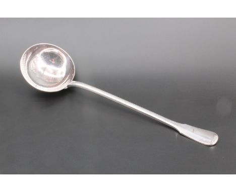 An early 20th Century French heavy white metal ladle, having a slender stem with broad central rib, and a scroll-tipped fiddl