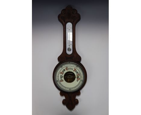 A late Nineteenth Century carved oak aneroid banjo barometer, 79 cm
