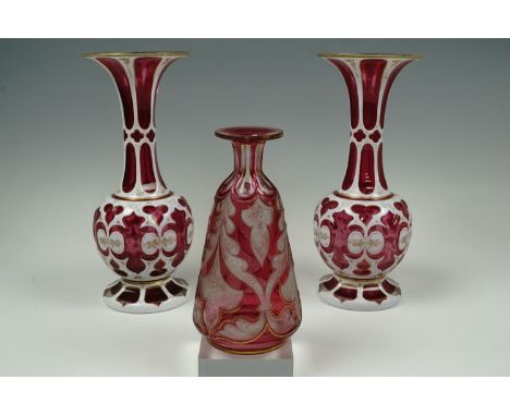 A pair of mid Nineteenth Century Bohemian style cased ruby glass vases together with a ruby flashed, wheel-cut and gilt-enric