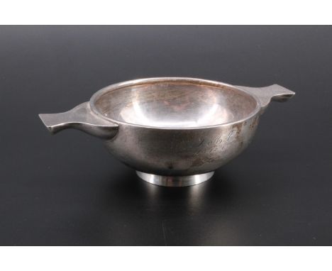 An Art Deco influenced silver porringer shaped bowl with lug handles, engraved on one side J.A.C. 18.12.61, London, 1960, 14 