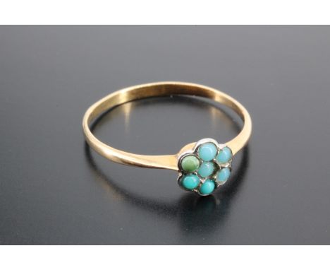 A late 19th / early 20th Century turquoise flowerhead cluster ring, comprising turquoise cabochons  bezel set on a yellow met