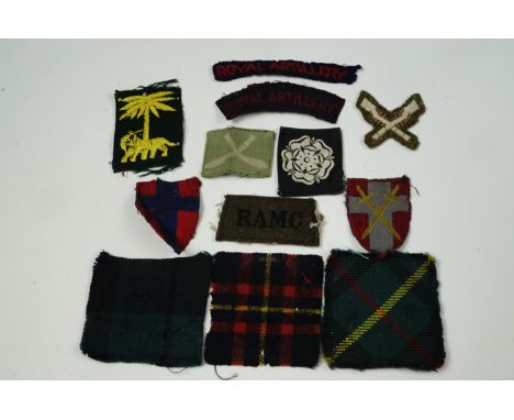 A small group of British army cloth insignia including tartan badge backings