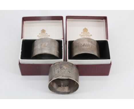 A pair of silver napkin rings by Mappin &amp; Webb Ltd, London, 1963, in original cartons, together with another similar by J