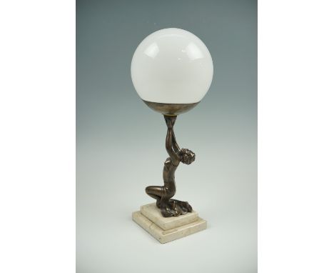 A Art Deco figural table lamp having a polished marble base and a spherical glass globe, 40 cm