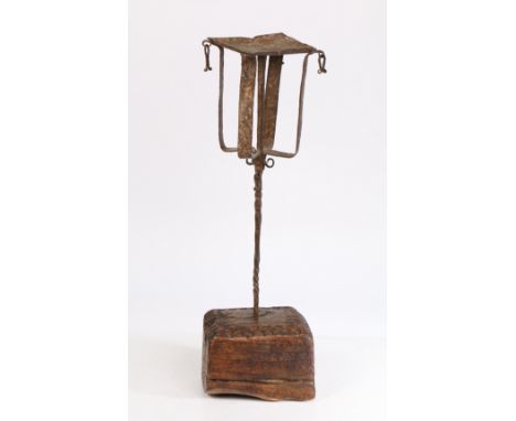 Iron and timber hanging lamp holder, possible for cruise lamps, with a platform and cage above a twist step and chip carved b