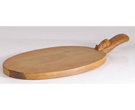 A Robert "Mouseman" Thompson chopping board, the oval board with a handle set with a mouse, 39cm long