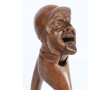 A late 19th Century/ early 20th Century Black Forest lever-action nut cracker, carved as a jockey, 23cm long