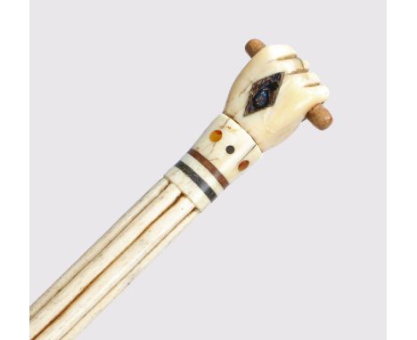 A George III whalebone and baleen walking stick, the handle in the form of a clenched fist holding a baton above a reeded and