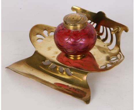 An Art Nouveau Loetz art glass inkwell, Austrian circa 1900, the ruby glass with a wavy design to the body and having brass c