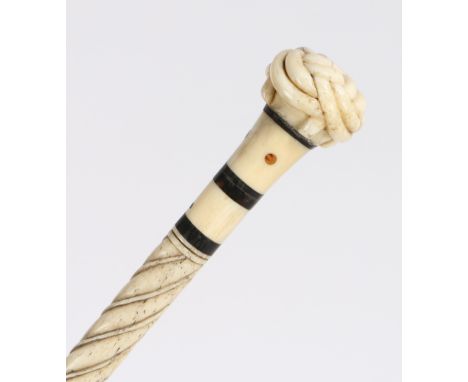 A 19th century whalebone tortoiseshell and inalid walking stick, the handle carved as a trinity knot above a turned column wi