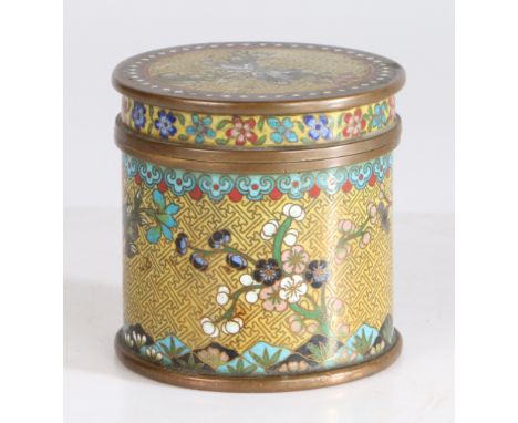 A Chinese Cloisonne enamel cylindrical pot and cover, having a yellow ground set with floral blossom trees, 9cm high 9cm diam