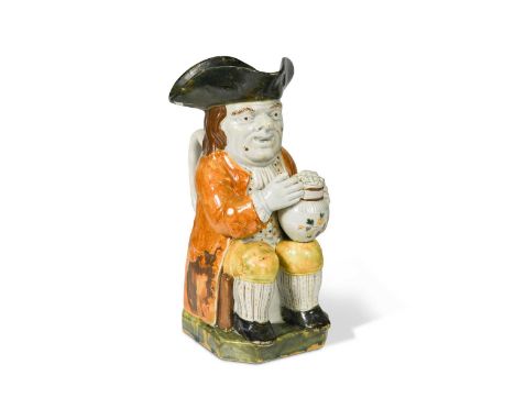 seated, holding a foaming jug of ale, wearing an ochre coloured coat and yellow breeches, on a canted green base,25cm highFoo
