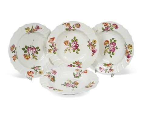 painted to the centres with a floral bouquet, the spirally moulded fluted borders with further floral sprays, comprising; twe