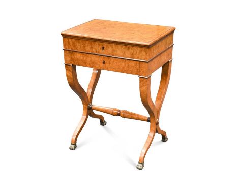 with hinged top opening to reveal a mirror and compartmentalized tray, above a drawer, on x framed legs with brass lion paw f