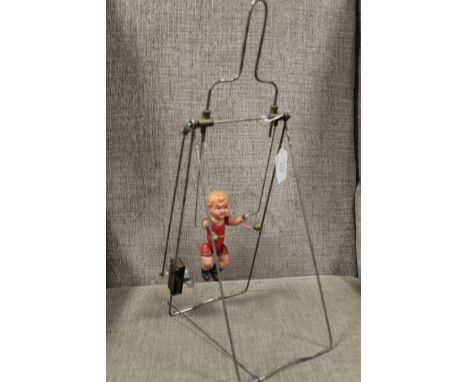 A VINTAGE CLOCKWORK 'CHILD ON A SWING', with metal frame, overall H 44 cm